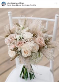 a bouquet of flowers sitting on top of a white chair