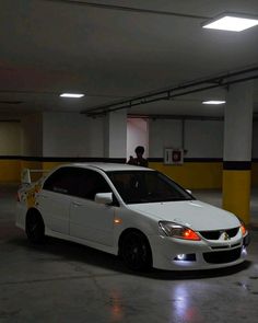 a white car parked in a parking garage