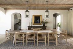 the dining room table is surrounded by chairs and an area rug in front of it