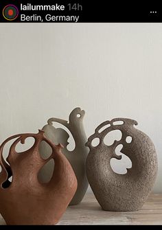 three vases sitting on top of a wooden table