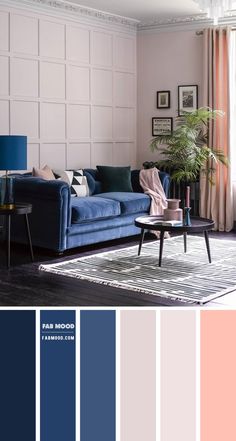 a living room with blue couches, pink walls and white paneled panels on the wall