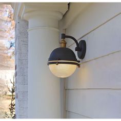 an outdoor light on the side of a house