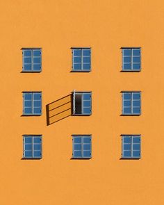 an orange building with several windows and a ladder