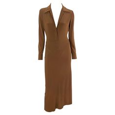 From the Spring/Summer 1996 Donna Karan collection, this light brown stretch dress debuted on the season's runway on Georgina Grenville. This form-fitting dress features long sleeves, a fold-over collar, internal thong, and a plunging neckline. Approximate measurements: Size - Petite Bust: 32" (can stretch and be made larger by undoing buttons) Waist: 25 - 28" Hips: 30 - 42" Shoulder to Hem: 52" Shoulder to cuff: 23.5" Armpit to cuff: 18" 63% Rayon, 25% Nylon, 12% Spandex Brown Bodycon Long Sleeve Midi Dress, Brown Long Sleeve Bodycon Midi Dress, 1996 Runway, Georgina Grenville, Donna Karan Dress, Form Fitting Dress, Stretch Dress, Day Dress, Donna Karan