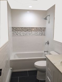 a bathroom with a toilet, sink and bathtub