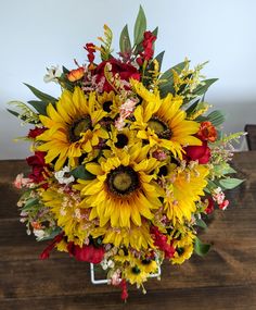 a bouquet of sunflowers and other flowers on a table