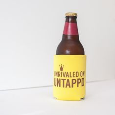 a beer bottle with the label untapped on it sitting on a white surface