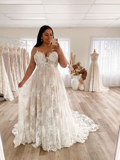 a woman is taking a selfie in her wedding dress while looking at her phone