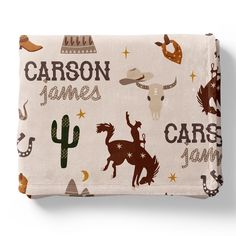 a blanket with an image of horses and cactuses on it, along with the words caron james