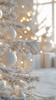 a white christmas tree with ornaments on it