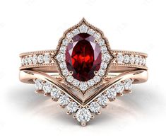 a ring with a large red stone surrounded by diamonds