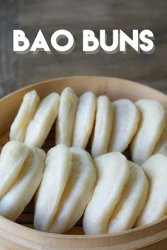 some kind of food in a wooden bowl with the words bao buns above it