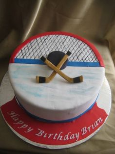 a birthday cake for a hockey player with an image of the net and puck on it