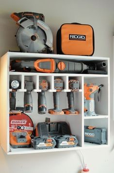 a white shelf filled with lots of different tools and construction equipment on top of it