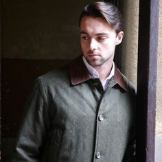 This olive green wool coat has features subtle diamond-shaped quilt-like topstitching and a brown collar. The handsome 1990s Italian vintage overcoat closes in the front with five faux tortoiseshell buttons and is fully lined in a shimmering dichroic red and green satin polyester fabric. Note that this is a short size, as indicated by the sleeve length measurement and length of coat listed below. Brand Label: Tuscan Square (Made in Italy) Size: 44S US/UK Material: Wool Chest = 47 inches (119.38c Classic Quilted Jacket With Padded Collar, Classic Brown Quilted Jacket For Fall, Classic Quilted Jacket With Button Closure, Classic Quilted Sport Coat For Fall, Classic Fitted Olive Outerwear, Classic Olive Formal Outerwear, Classic Olive Outerwear With Button Closure, Classic Olive Outerwear For Business, Classic Quilted Jacket With Buttons