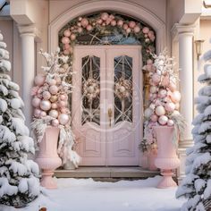 a pink door decorated with christmas decorations and ornaments in front of snow - covered trees