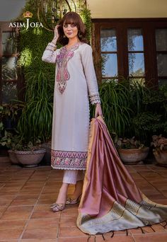 Product Description: This cream-pink ensemble from Asim Jofa’s Essentials collection exudes a delicate femininity that is both sophisticated and charming. The meticulously embroidered center panel and sleeve borders on the cambric shirt showcase the designer's artistry, while the multi-color yard-dyed dupatta lends a subtle yet alluring touch of color to the outfit. Indulge in luxury and treat yourself to something special. DESIGN DETAILS: 1 embroidered center panel on cambric 0.7 meter embroidered border for front daman on cambric 1 meter embroidered border for the sleeve on cambric 1.8 meter plain wide width cambric for side panels, back & sleeves 2.5 meter yard dyed dupatta Asim Jofa, Pakistani Lawn Suits, Organza Sleeves, Lawn Suits, Embroidered Neckline, Suit Fabric, Pakistani Outfits, Green Suede, Best Wear