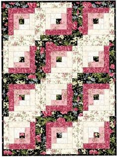 a pink and white quilt with flowers on it's sides, in the center