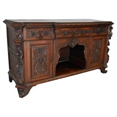 an old wooden sideboard with carvings on it