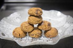 a stack of cookies sitting on top of a white lace doily in front of a black table