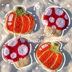 three small crocheted pumpkins are sitting on a tablecloth with the words gourmet needle centers