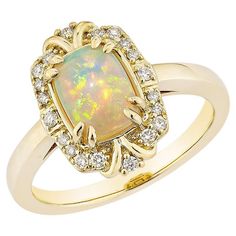 Sunita Nahata presents a stunning Ethiopian opal cabochon ring, adorned with white diamonds. This gemstone, renowned for its historical significance, is believed to bring good luck, protection, and divine hope. Its metaphysical benefits include promoting vibrant energy and attracting luck, success, and prosperity. The colorful gems make it an ideal cocktail and statement ring. Ethiopian Opal Fancy Ring in 14Karat Yellow Gold with White Diamond. Ethiopian Opal: 0.85 carat, 8X6mm size, oval shape. Fancy Rings, Cabochon Ring, Naha, Gorgeous Jewelry, White Diamonds, Ethiopian Opal, Statement Ring, White Diamond, Diamond White