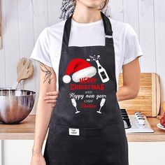 a woman wearing an apron and santa hat