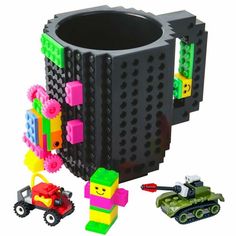 a lego coffee mug with some toys around it