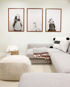 a living room with three pictures on the wall and a couch in front of it