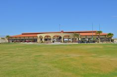 an empty field in front of a large building