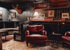 a living room filled with furniture and a deer head mounted to the wall