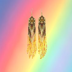 These stunning and sparkling Yawanawa earrings come from Aldeia Yawarany in Acre, Brazil. The Yawanawa are revered for their gorgeous beadwork and earrings. These items have been collected from the daughter of the Cacique, and the women of the village to raise money for the recent floods in Tarauaca. All earrings are one of a kind, hand made and take months to create. Product Description: 1.25'' width and 8'' inch dangling drop with ombre beads and sacred kene design. Traditional Round Bead Earrings For Festivals, Yellow Bohemian Earrings For Festive Occasions, Handmade Ceremonial Dangle Earrings, Artisan Gold Beaded Festival Earrings, Artisan Gold Beaded Earrings For Festivals, Artisan Gold Beads Earrings For Festival, Artisan Long Drop Beaded Earrings, Handmade Traditional Beaded Earrings For Festivals, Traditional Handmade Beaded Earrings For Festivals