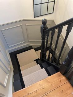 a staircase with carpeted steps and railings