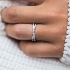 a woman's hand wearing a diamond ring