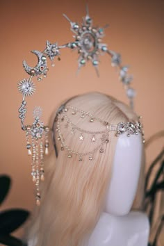 the headpiece is adorned with crystal stars and beads, along with other jewelry pieces