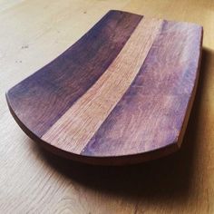 a wooden cutting board sitting on top of a table