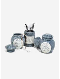 three jars with writing on them sitting next to each other in front of a white background