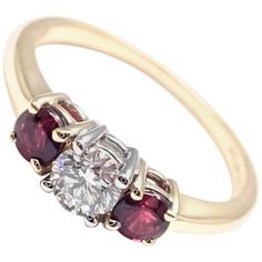 18k Yellow Gold and Platinum Diamond And Ruby Three Stone Band Ring by Tiffany & Co. With 1 Round Brilliant Cut Diamond VS1 clarity, G color, Total weight Approx .50ctw 2 Round rubies total weight approx. 0.50ct Details: Ring Size: 6 Width: 6mm Weight: 2.7 grams Stamped Hallmarks: Tiffany&Co 750 PT950 **Free Shipping within the United States** Your Price: $7,500 T2697oddd Luxury Multi-stone Round Cut Ruby Ring, Luxury Ruby Ring With Multi-stone Round Cut, Luxury Round Cut Multi-stone Ruby Ring, Luxury Ruby Three Stone Rings, Luxury Red Three Stone Jewelry, Luxury Red Three-stone Jewelry, Fine Jewelry Yellow Gold Ruby Ring With Brilliant Cut, Luxury Gold Three-stone Ruby Ring, Luxury Gold Ruby Three Stone Ring