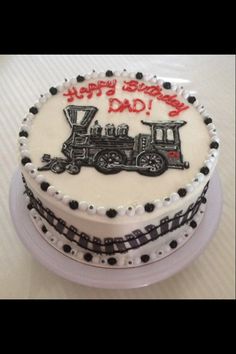 a birthday cake with a train design on it that says happy birthday to my dad