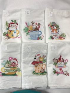 six embroidered tea towels with christmas designs on them