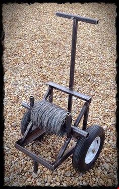 an old fashioned hand truck made out of wire and wood with wheels on the ground