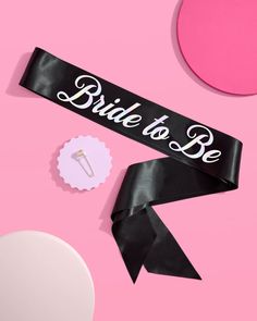 the bride to be sash is laying on top of a pink background