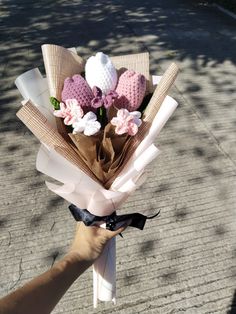 a person holding a bouquet of flowers in their hand