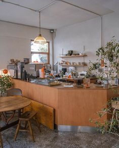 a kitchen filled with lots of counter top space and wooden furniture next to a window