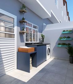 a laundry room with a washer and dryer on the floor next to it