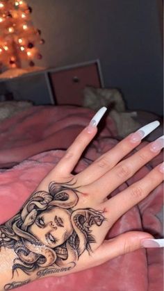 a woman's hand with a tattoo on it