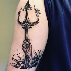 a man with a tattoo on his arm holding an anchor