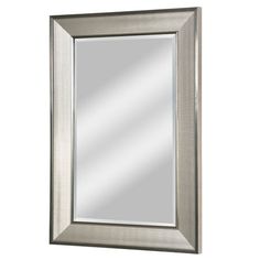 a silver framed mirror on a white wall