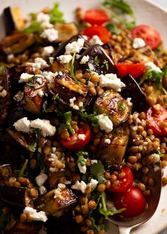 a white plate topped with vegetables and feta cheese