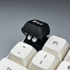 a black and white computer keyboard with eyes on it